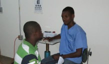 Faustin counseling a patient